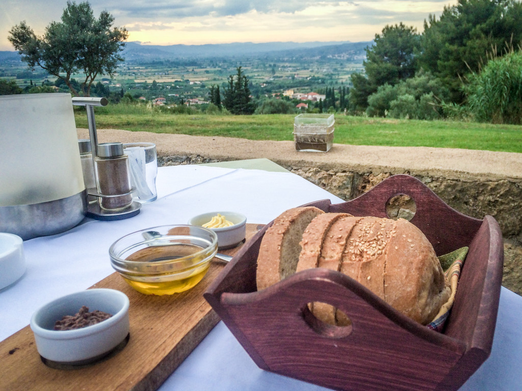 Enjoying my olive oil and olive spread with a view of olive trees at Hotel Europa, Ancient Olympia