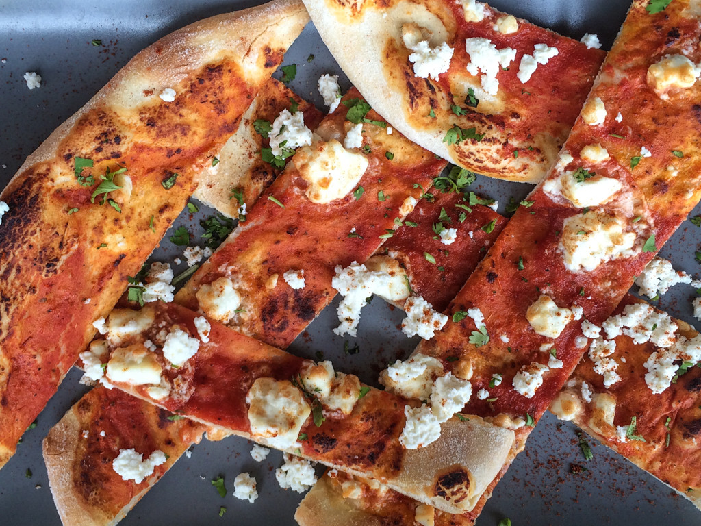 Pita bread with tomato sauce and feta cheese